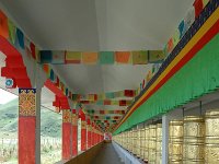 China  Tagong. Grasslands. Prayer wheels surround the outside of the second monastery. In additional pray flags are scattered through the monastery. : Asia, China, Prayer Wheel, Tagong Grassland, Temple